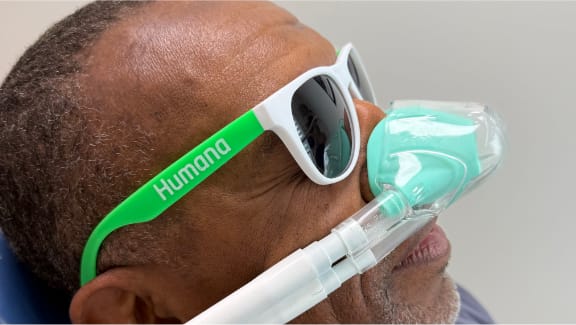 Patient wearing protective glasses and a dental sedation mask