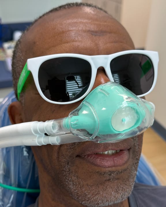 A relaxed patient receiving comfortable, sedation-supported care at Tomlinson Dental in Tampa