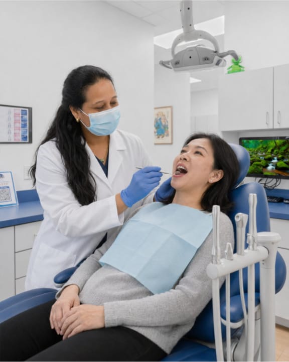 Dr. Gail inspecing the oral health of a patient at Tomlinson Dental in Tampa